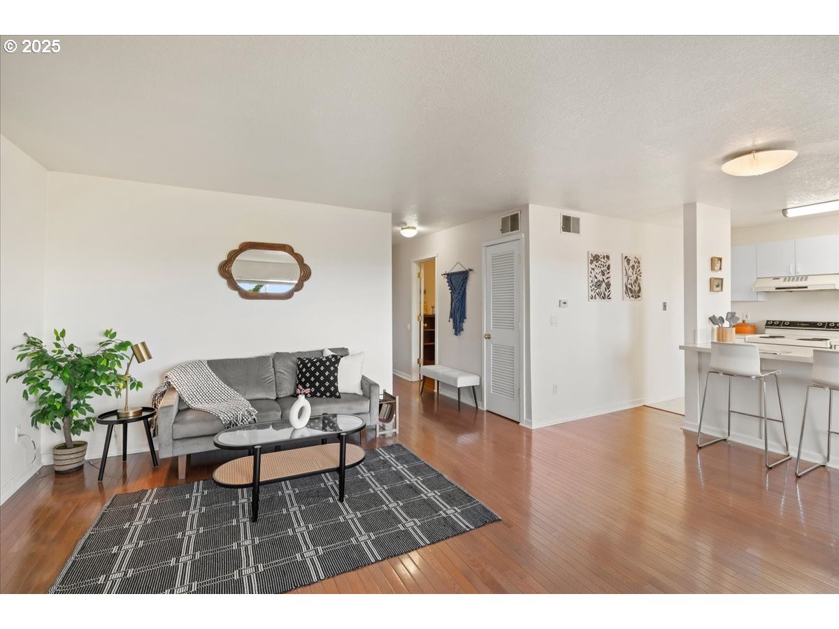 3515 Southwest Barbur Boulevard, Unit P1 Portland, OR 97239 - Photo 9 of 35 a living room with furniture and wooden floor