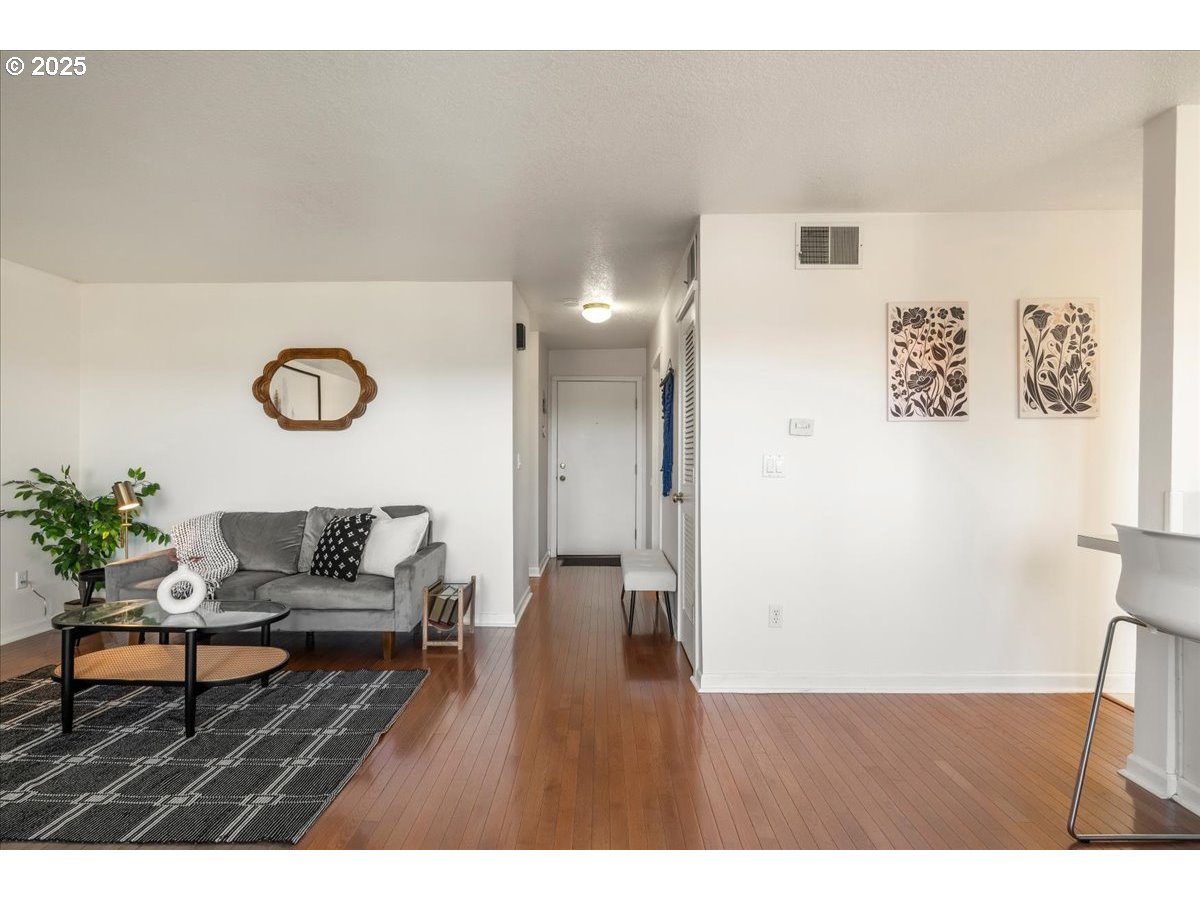 3515 Southwest Barbur Boulevard, Unit P1 Portland, OR 97239 - Photo 10 of 35 a living room with furniture and wooden floor
