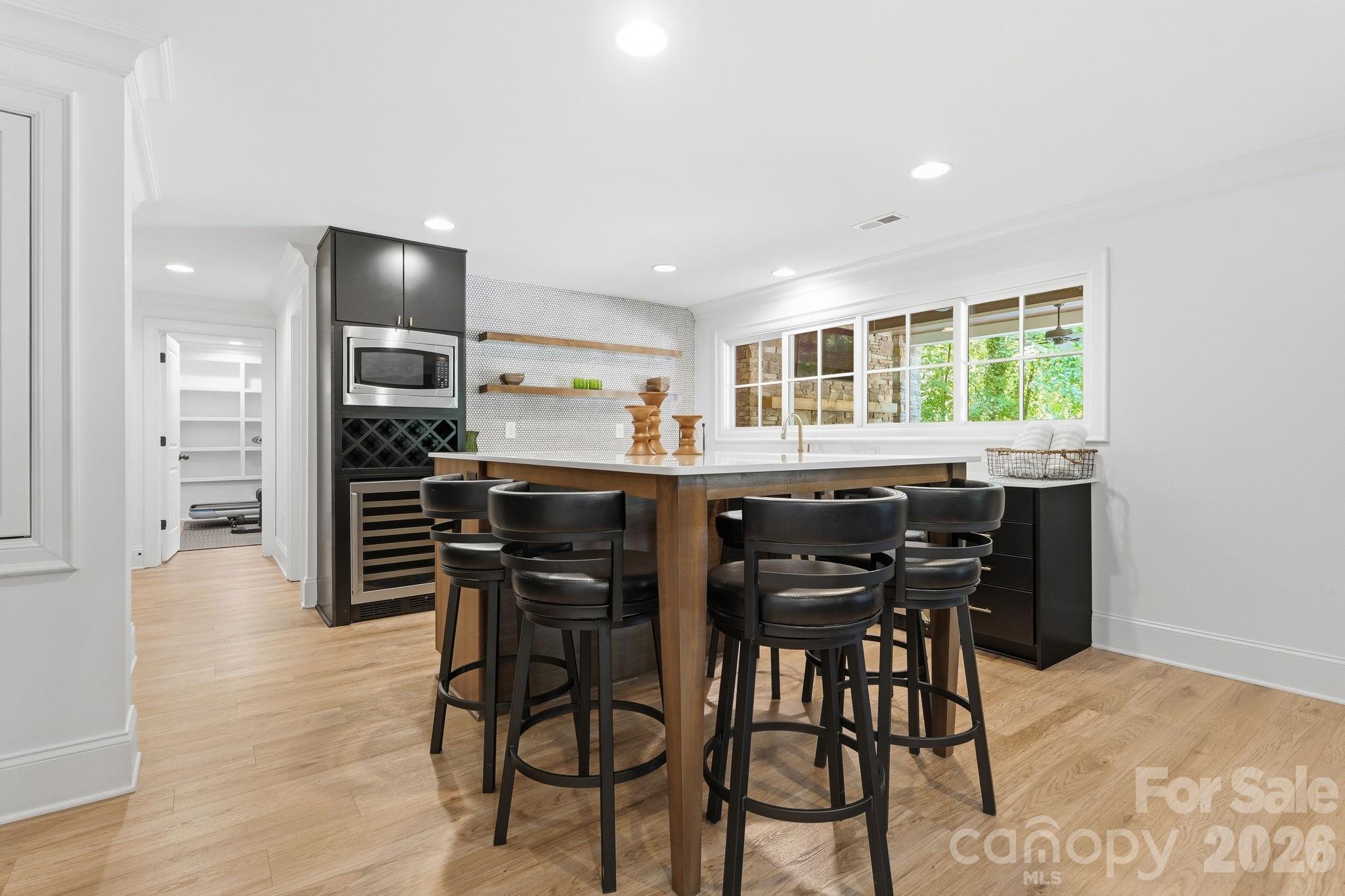 235 Grey Road Davidson, NC 28036 - Photo 29 of 42 a kitchen with stainless steel appliances kitchen island granite countertop a table and chairs in it