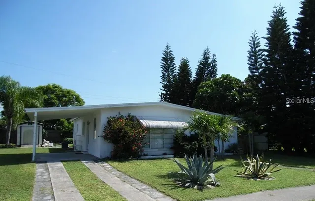 a view of a house with a yard and a garden