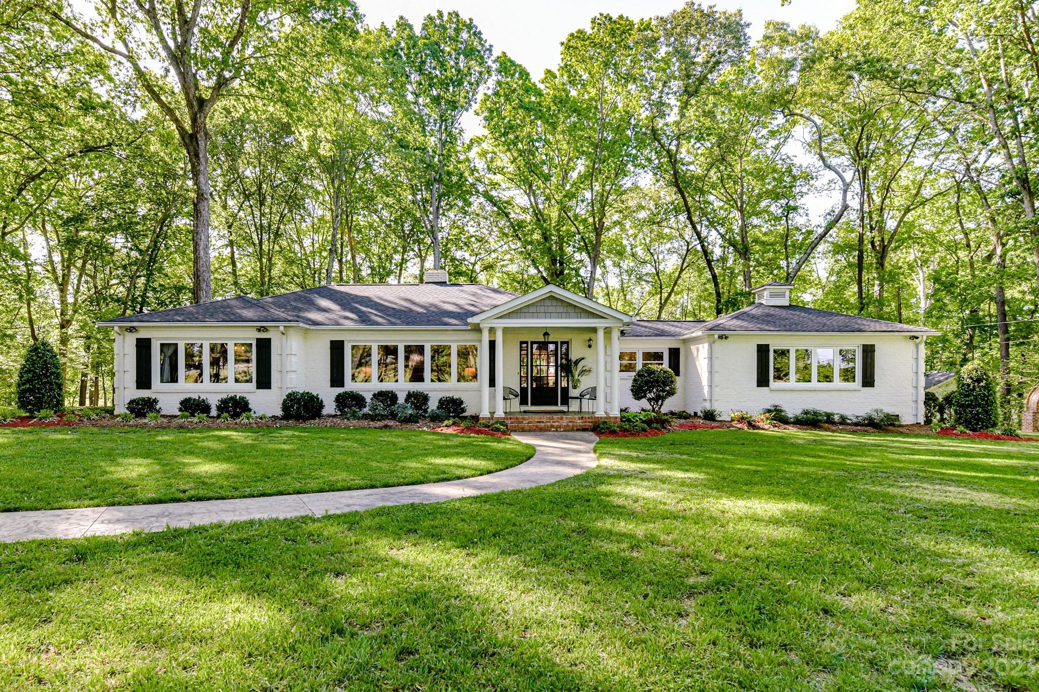 a front view of a house with a garden