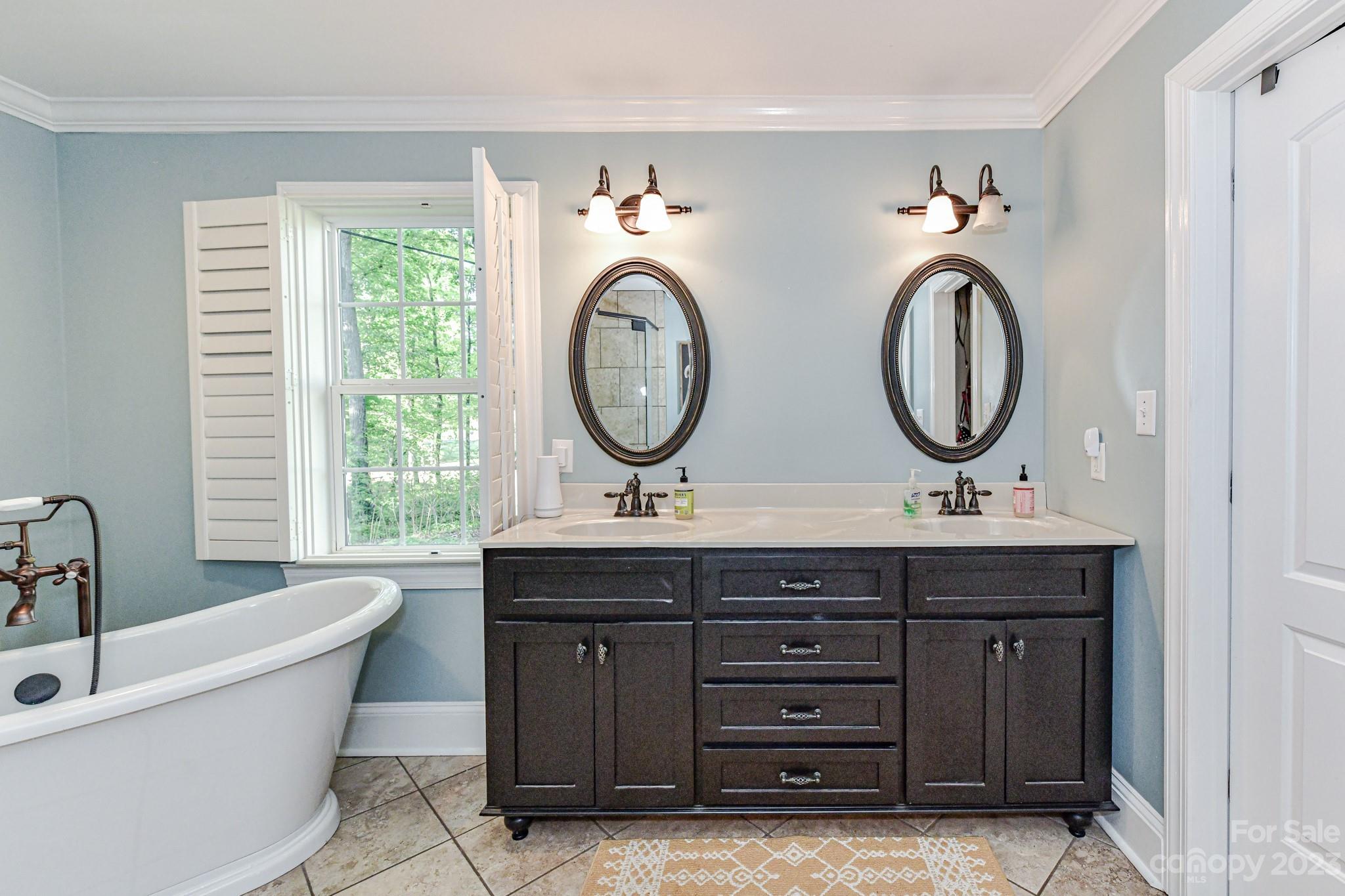 1050 Ben Black Road Midland, NC 28107 - Photo 21 of 48 a bathroom with a sink and a large mirror