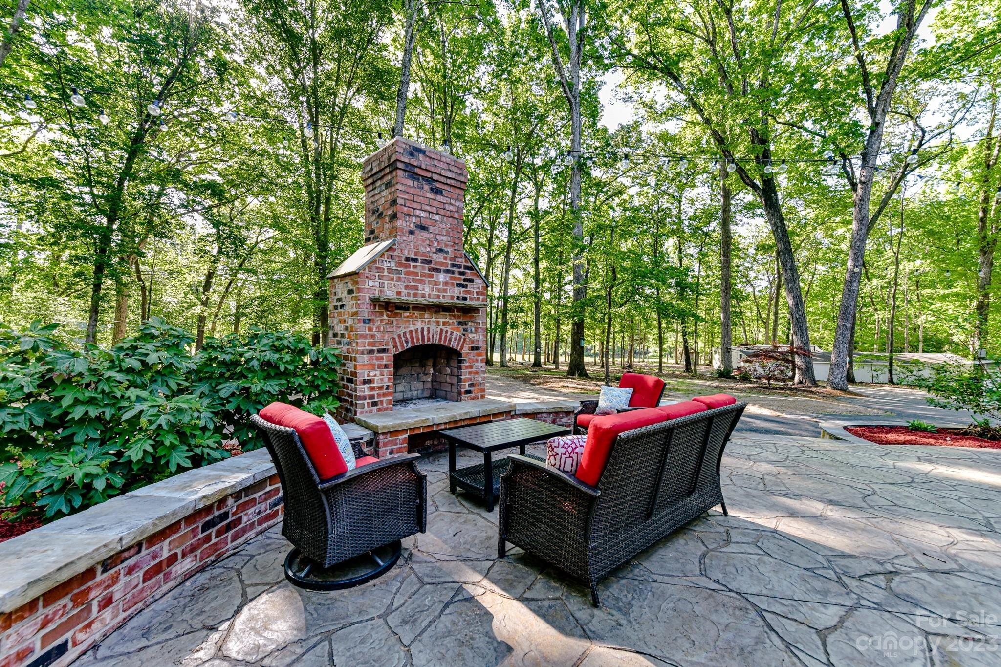 1050 Ben Black Road Midland, NC 28107 - Photo 32 of 48 a backyard of a house with table and chairs
