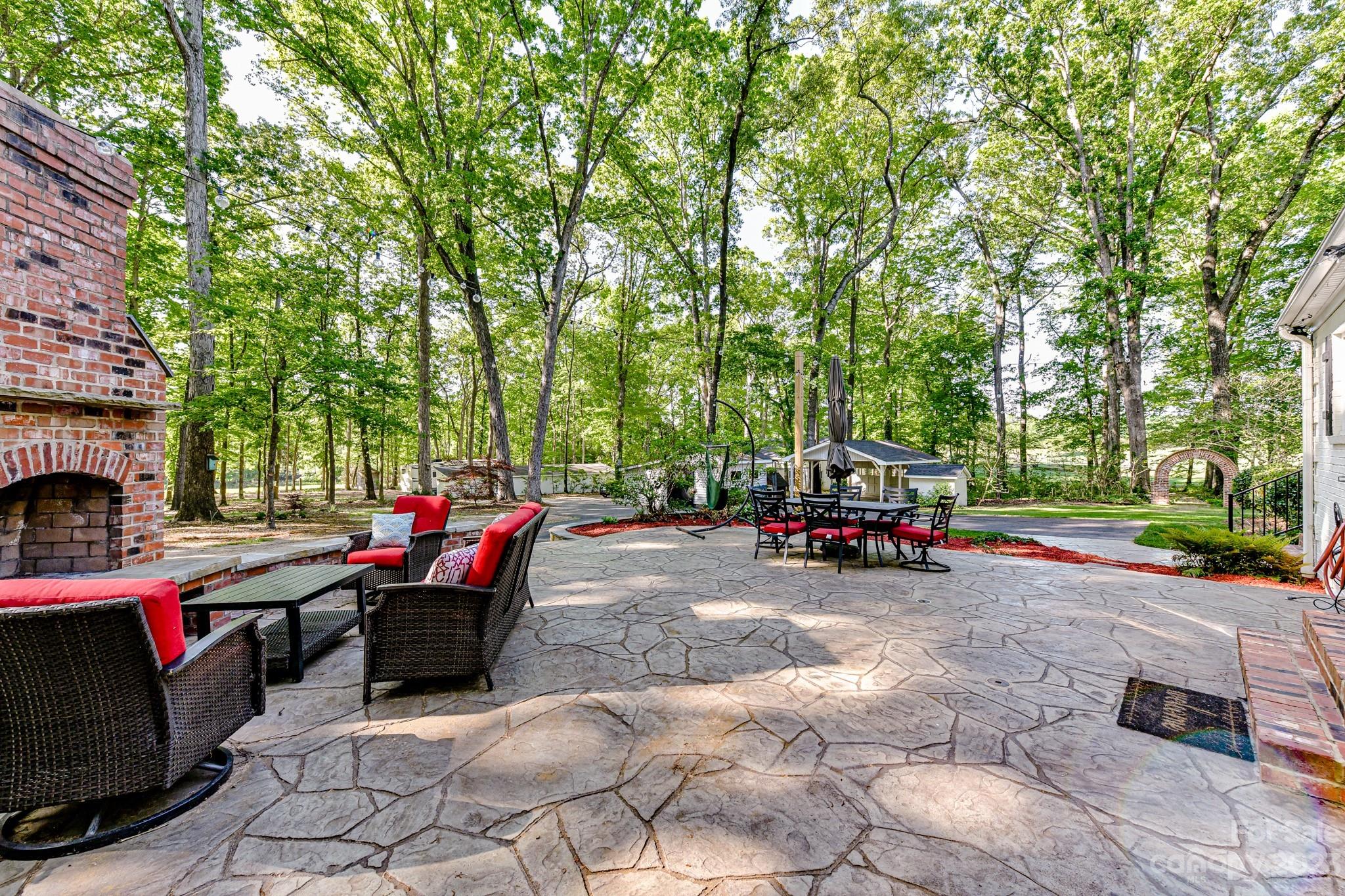 1050 Ben Black Road Midland, NC 28107 - Photo 33 of 48 a view of a patio with table and chairs and a fire pit