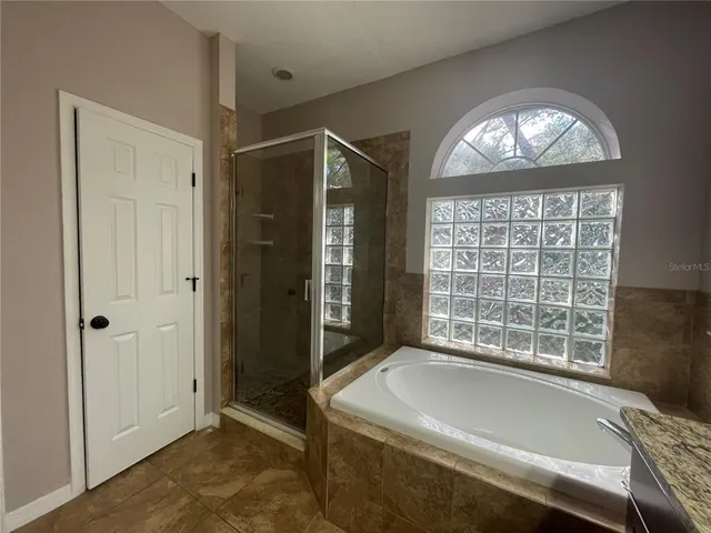 a spacious bathroom with a large tub and shower