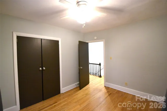 a view of hallway with wooden floor