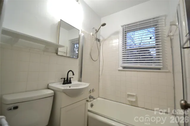 a bathroom with a sink a toilet and a shower