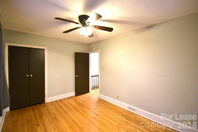 a bedroom with a bed and a ceiling fan