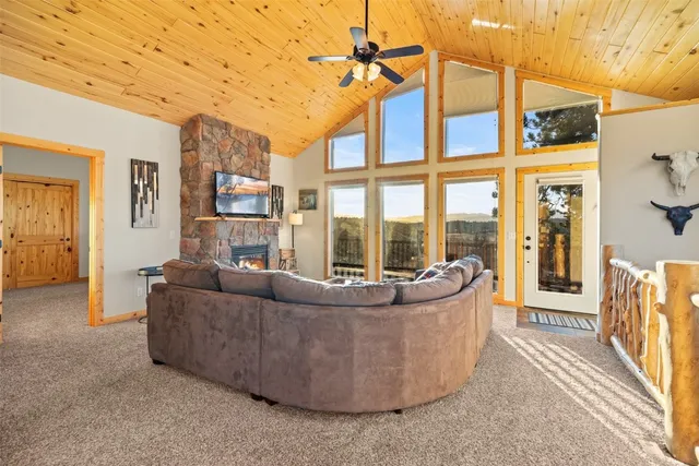 a living room with furniture and a floor to ceiling window
