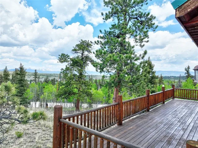 a view of balcony with wooden floor and fence