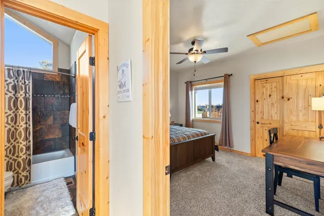 a bedroom with a bed and a view of bathroom