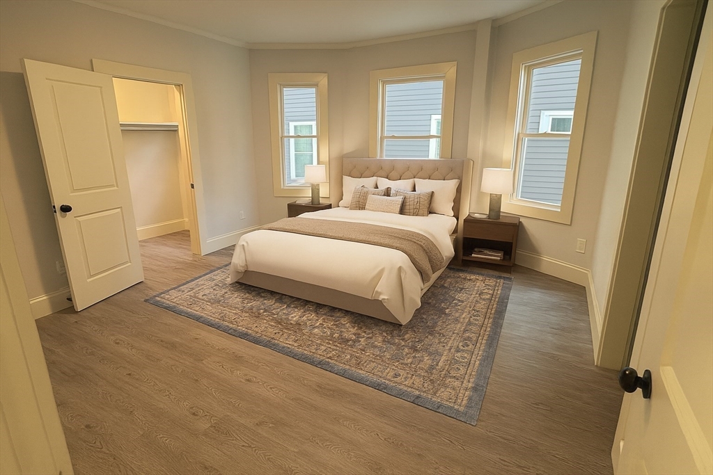 22 Browning Avenue, Unit 2 Boston, MA 02124 - Photo 4 of 10 a bedroom with a bed and wooden floor