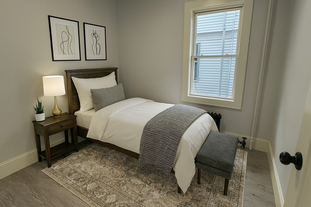 22 Browning Avenue, Unit 2 Boston, MA 02124 - Photo 8 of 10 a bedroom with a bed and a window