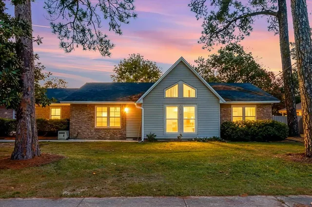 a front view of house with yard and green space