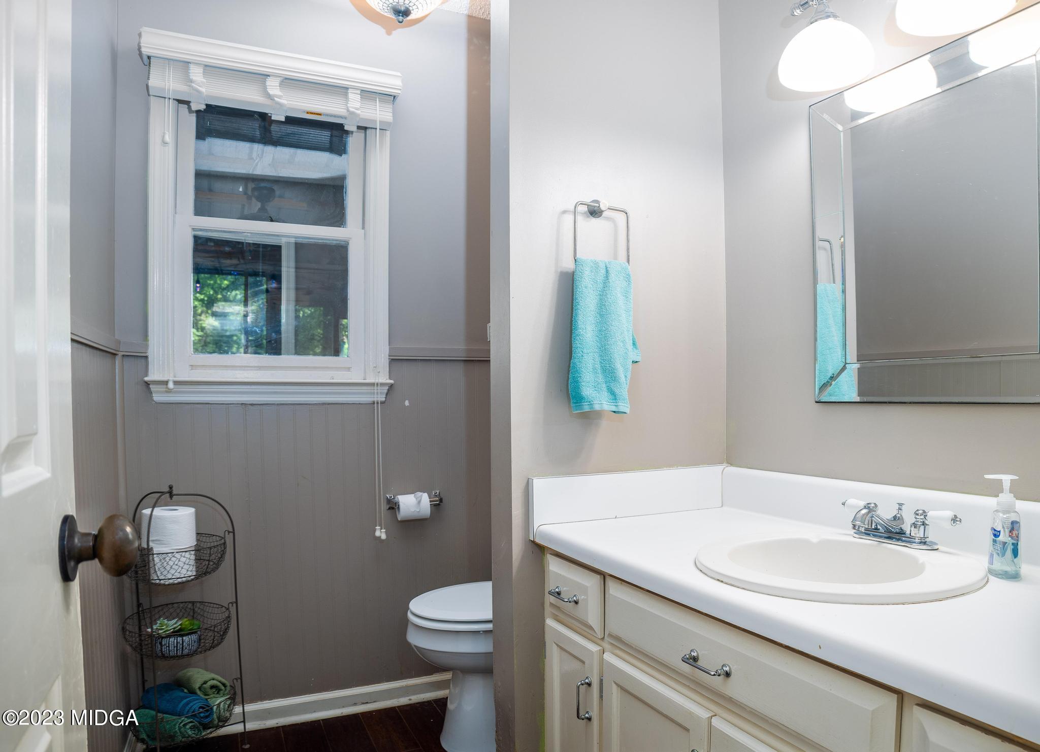 270 Castlegate Road Macon, GA 31210 - Photo 14 of 35 a bathroom with a granite countertop toilet sink and mirror