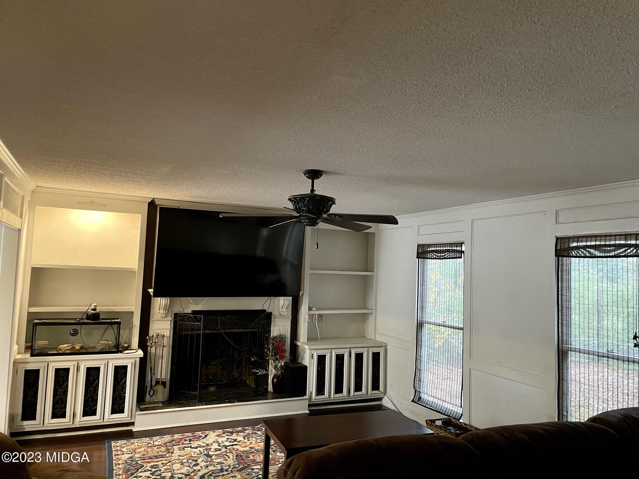 270 Castlegate Road Macon, GA 31210 - Photo 19 of 35 a living room with fireplace furniture and a flat screen tv