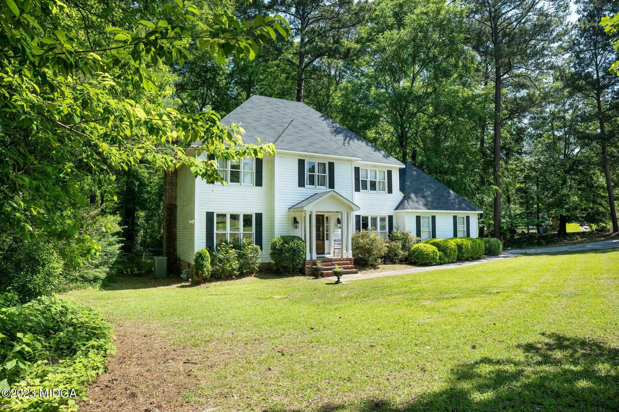 270 Castlegate Road Macon, GA 31210 - Photo 20 of 35 a front view of a house with a yard and trees