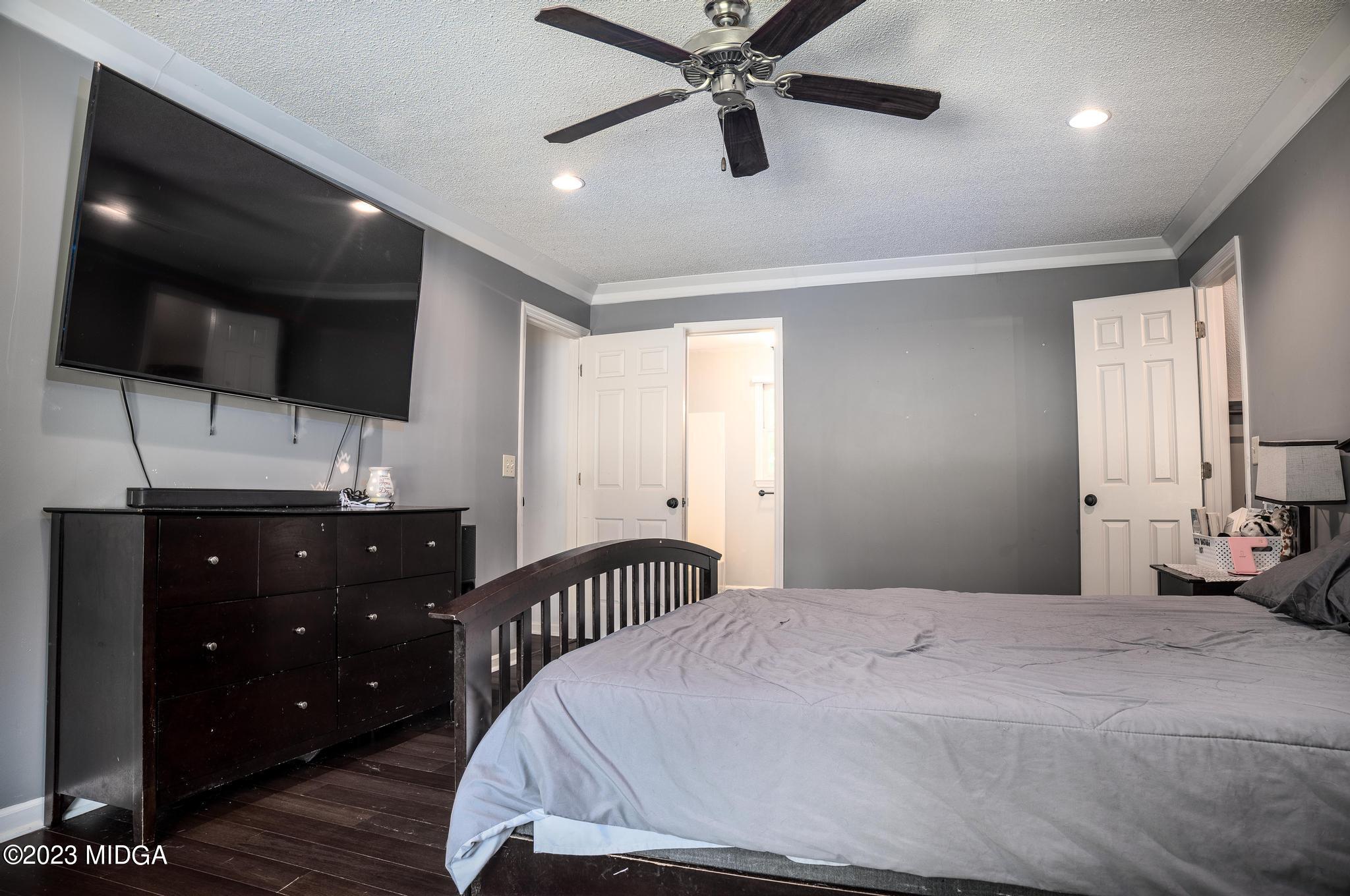 270 Castlegate Road Macon, GA 31210 - Photo 21 of 35 a bedroom with a bed and a flat tv screen on dresser
