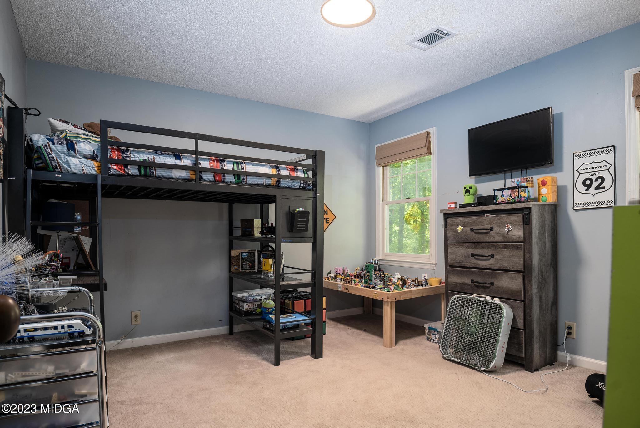 270 Castlegate Road Macon, GA 31210 - Photo 22 of 35 a bedroom with furniture and flat screen tv