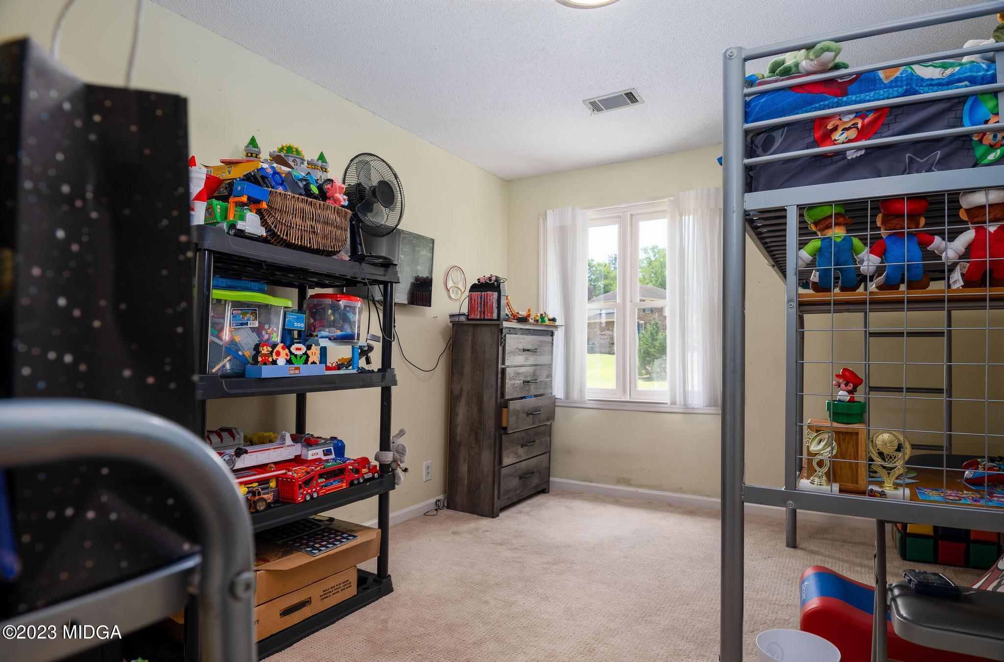 270 Castlegate Road Macon, GA 31210 - Photo 26 of 35 a living room with furniture and a floor to ceiling window