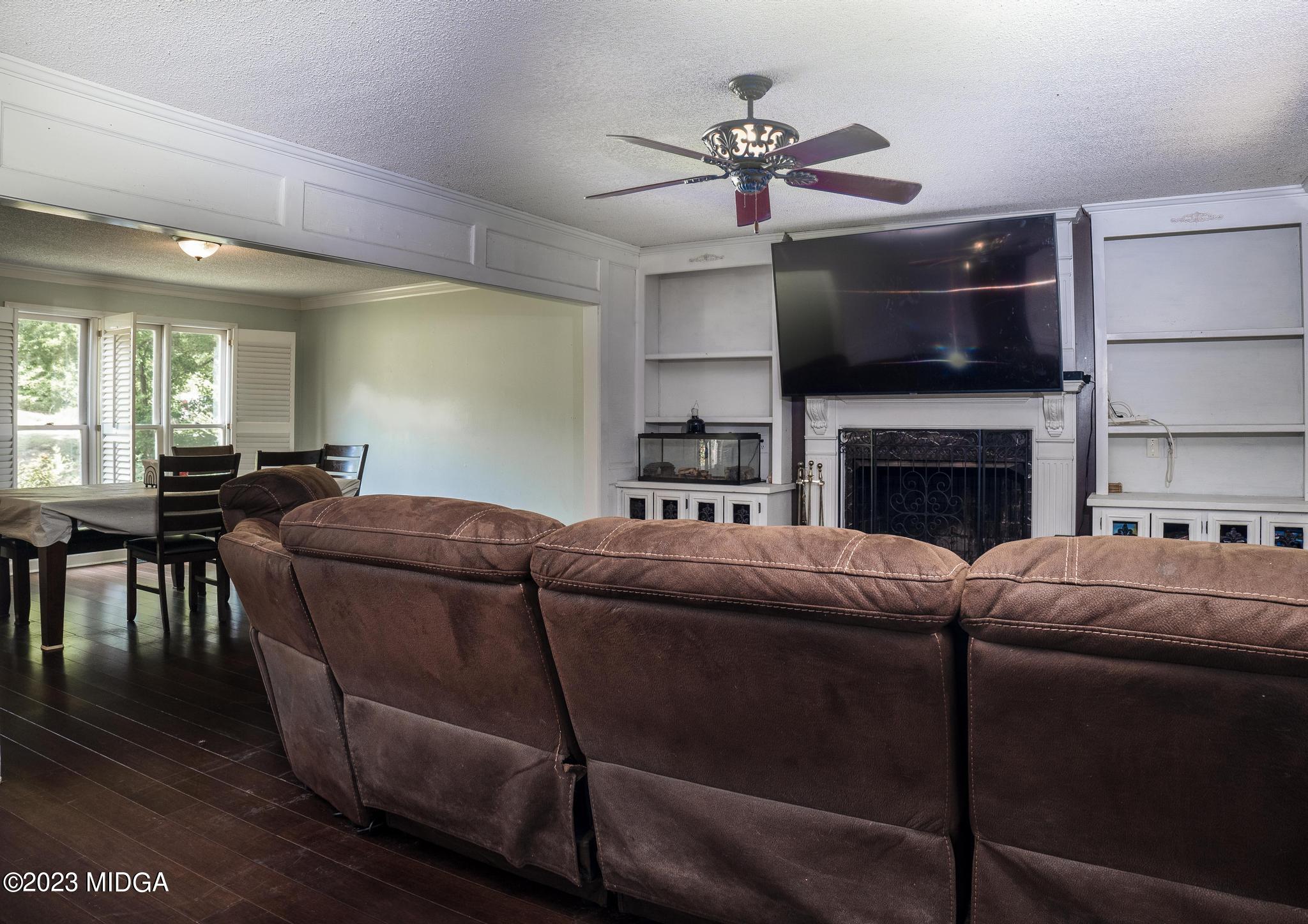 270 Castlegate Road Macon, GA 31210 - Photo 29 of 35 a living room with furniture a flat screen tv and kitchen view