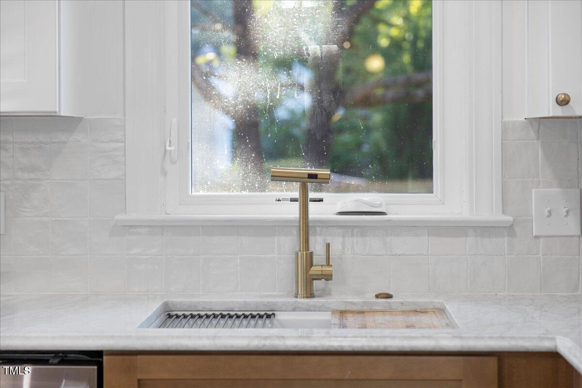 2117 Quail Ridge Road Raleigh, NC 27609 - Photo 22 of 67 a close view of sink and tap