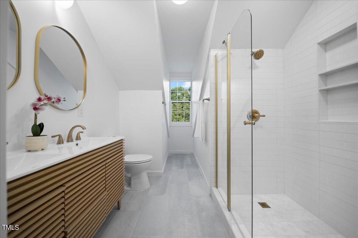 2117 Quail Ridge Road Raleigh, NC 27609 - Photo 48 of 67 a bathroom with a sink a toilet and shower