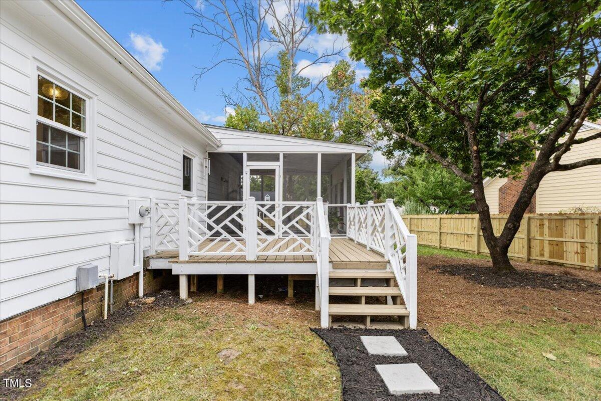 2117 Quail Ridge Road Raleigh, NC 27609 - Photo 59 of 67 a view of a house with a large window and wooden fence