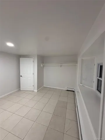 a view of an empty room with a kitchen