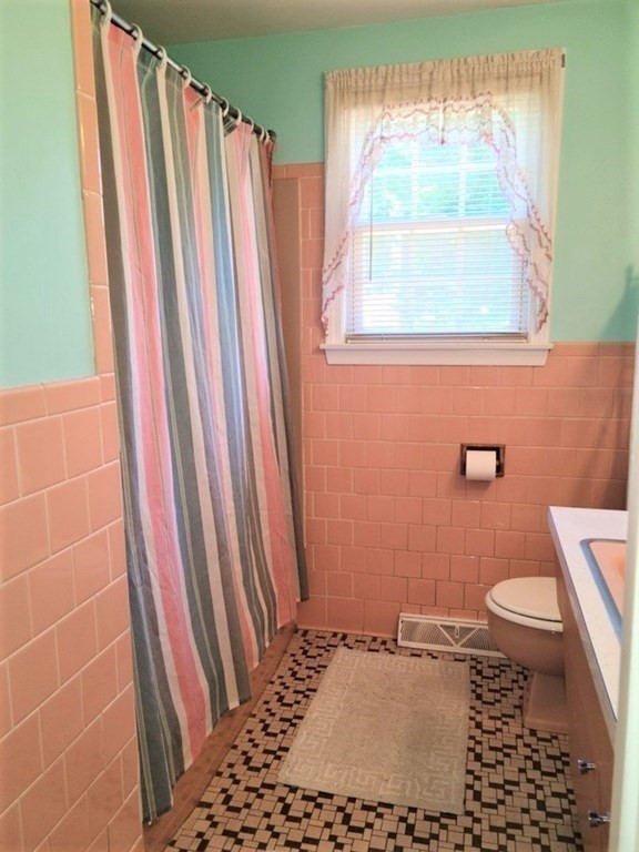 8 Fencourt Road Canton, MA 02021 - Photo 11 of 33 a bathroom with a sink a toilet a window and shower