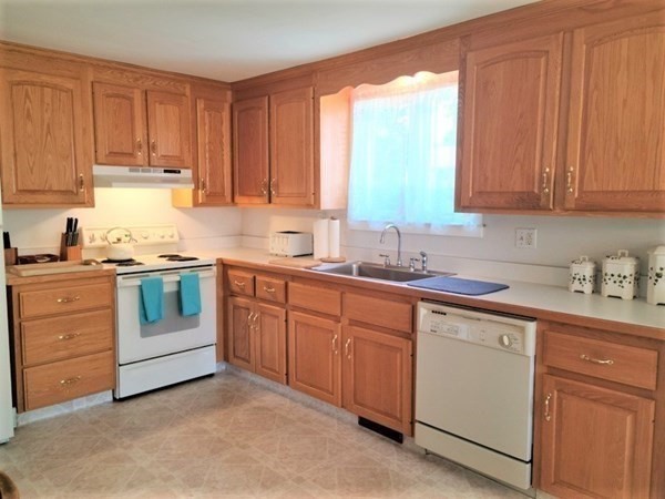 8 Fencourt Road Canton, MA 02021 - Photo 3 of 33 a kitchen with granite countertop white cabinets and white appliances