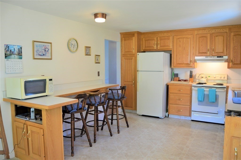 8 Fencourt Road Canton, MA 02021 - Photo 4 of 33 a kitchen with stainless steel appliances a stove a refrigerator and a refrigerator