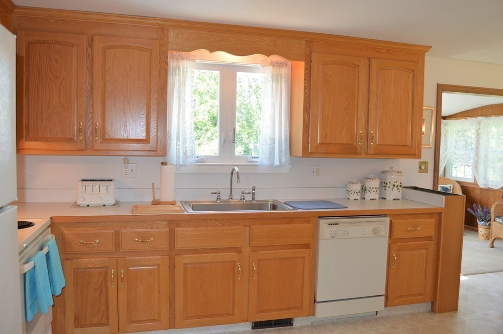 8 Fencourt Road Canton, MA 02021 - Photo 5 of 33 a kitchen with stainless steel appliances granite countertop a sink stove and cabinets