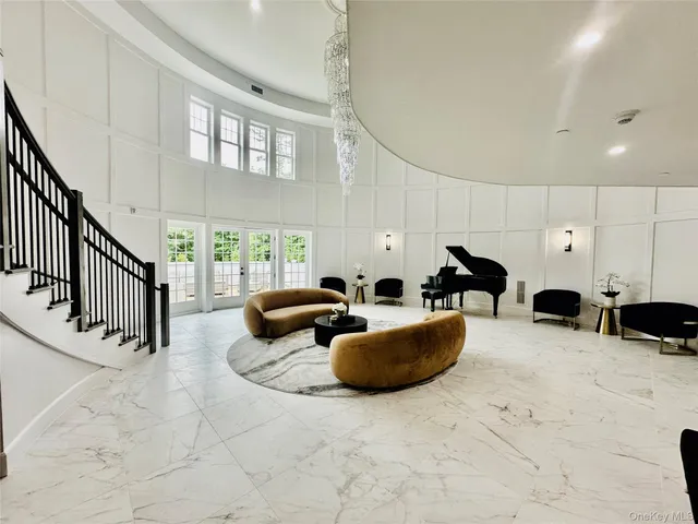 a front view of a house with swimming pool and sitting area