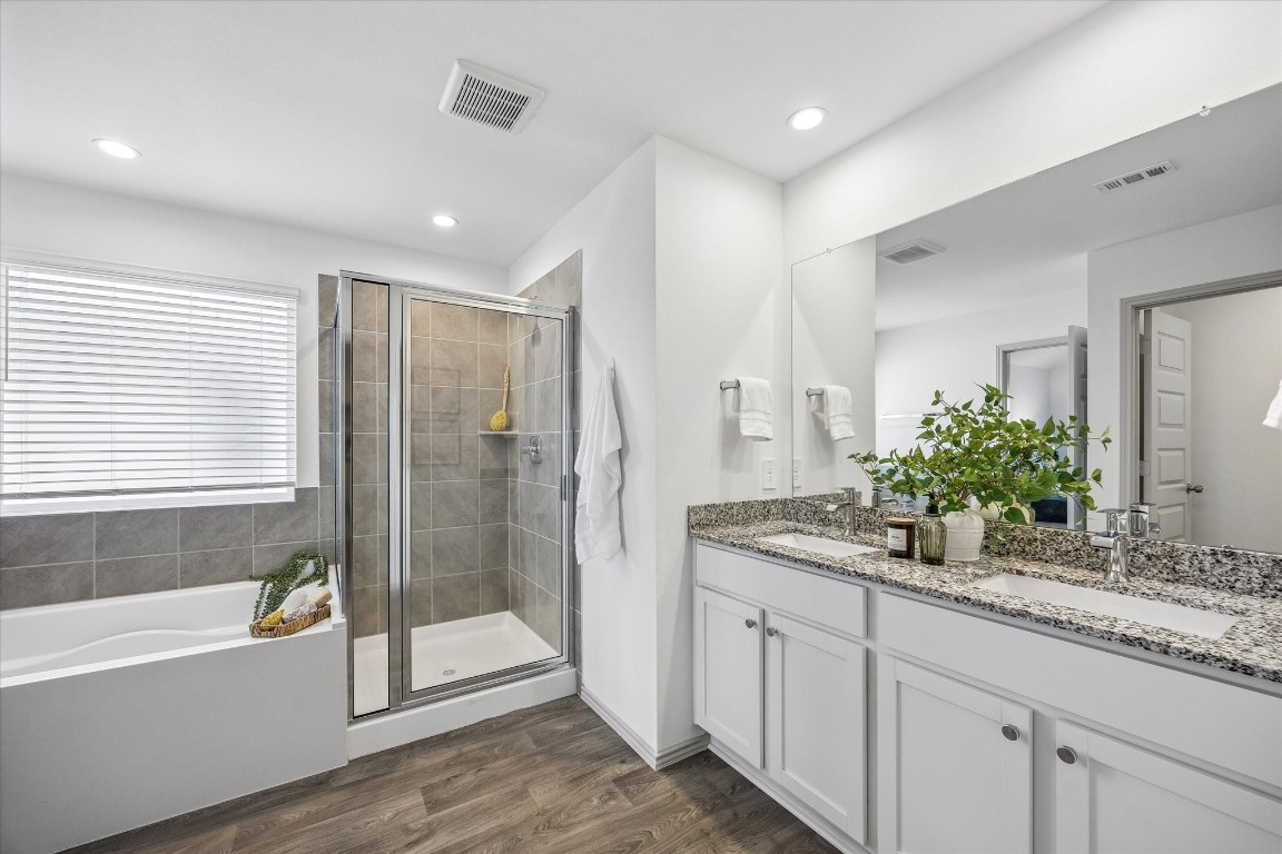3505 Rockefeller Road Texas City, TX 77591 - Photo 12 of 23 Primary suite bathroom with garden tub, walk-in shower, private toilet, dual sink vanity, and walk-in closet.