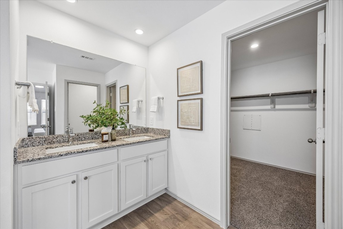 3505 Rockefeller Road Texas City, TX 77591 - Photo 13 of 23 Primary suite bathroom with garden tub, walk-in shower, private toilet, dual sink vanity, and walk-in closet.
