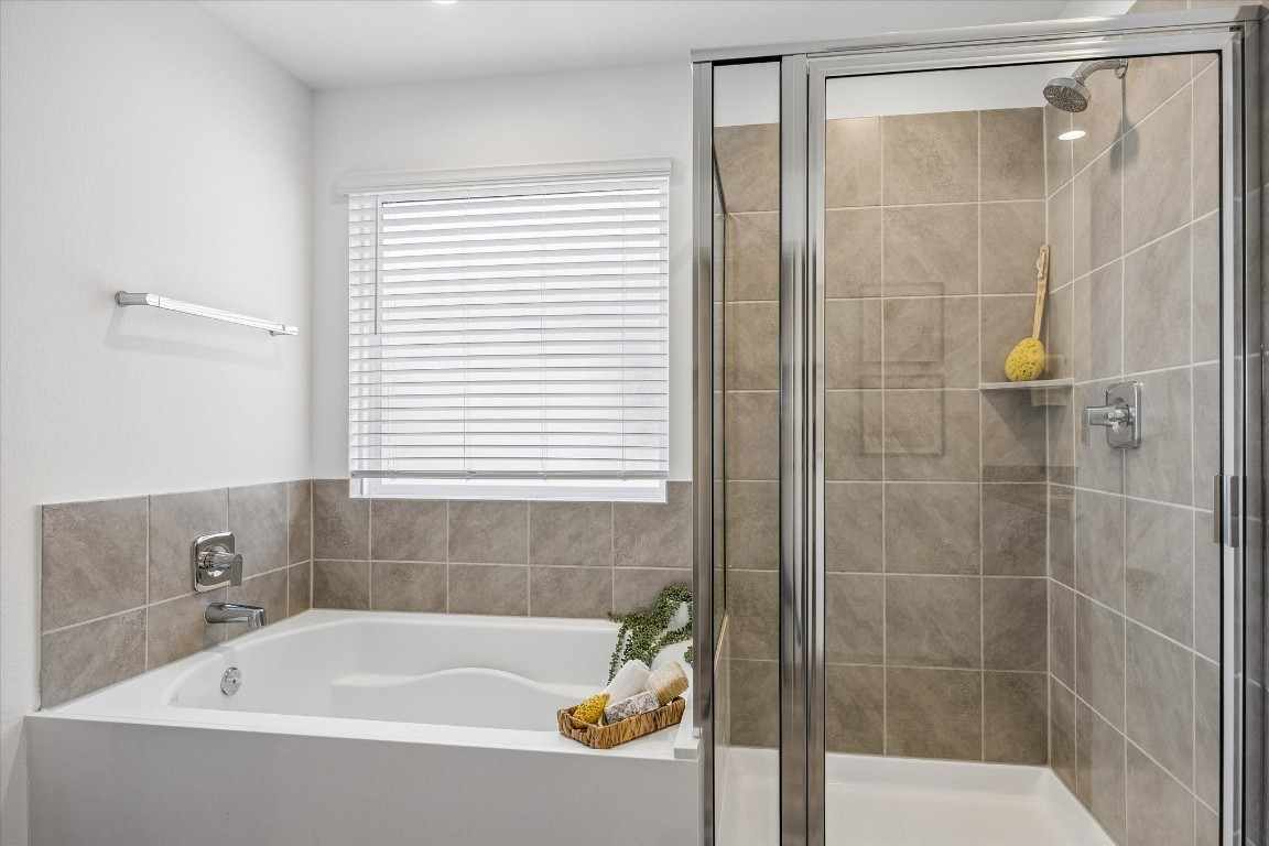 3505 Rockefeller Road Texas City, TX 77591 - Photo 14 of 23 Primary suite bathroom with garden tub, walk-in shower, private toilet, dual sink vanity, and walk-in closet.