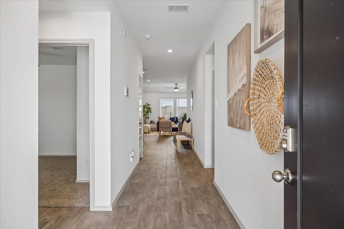 3505 Rockefeller Road Texas City, TX 77591 - Photo 5 of 23 Welcome in! As you step through the front door, you're greeted by a long hallway leading to the main living area. On the left side of the hallway, you'll find two bedrooms and a full bathroom.