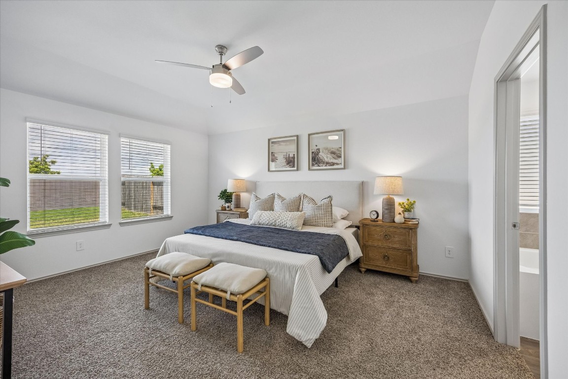 3505 Rockefeller Road Texas City, TX 77591 - Photo 10 of 23 Spacious primary bedroom with large windows, abundant natural light, and peaceful backyard views.