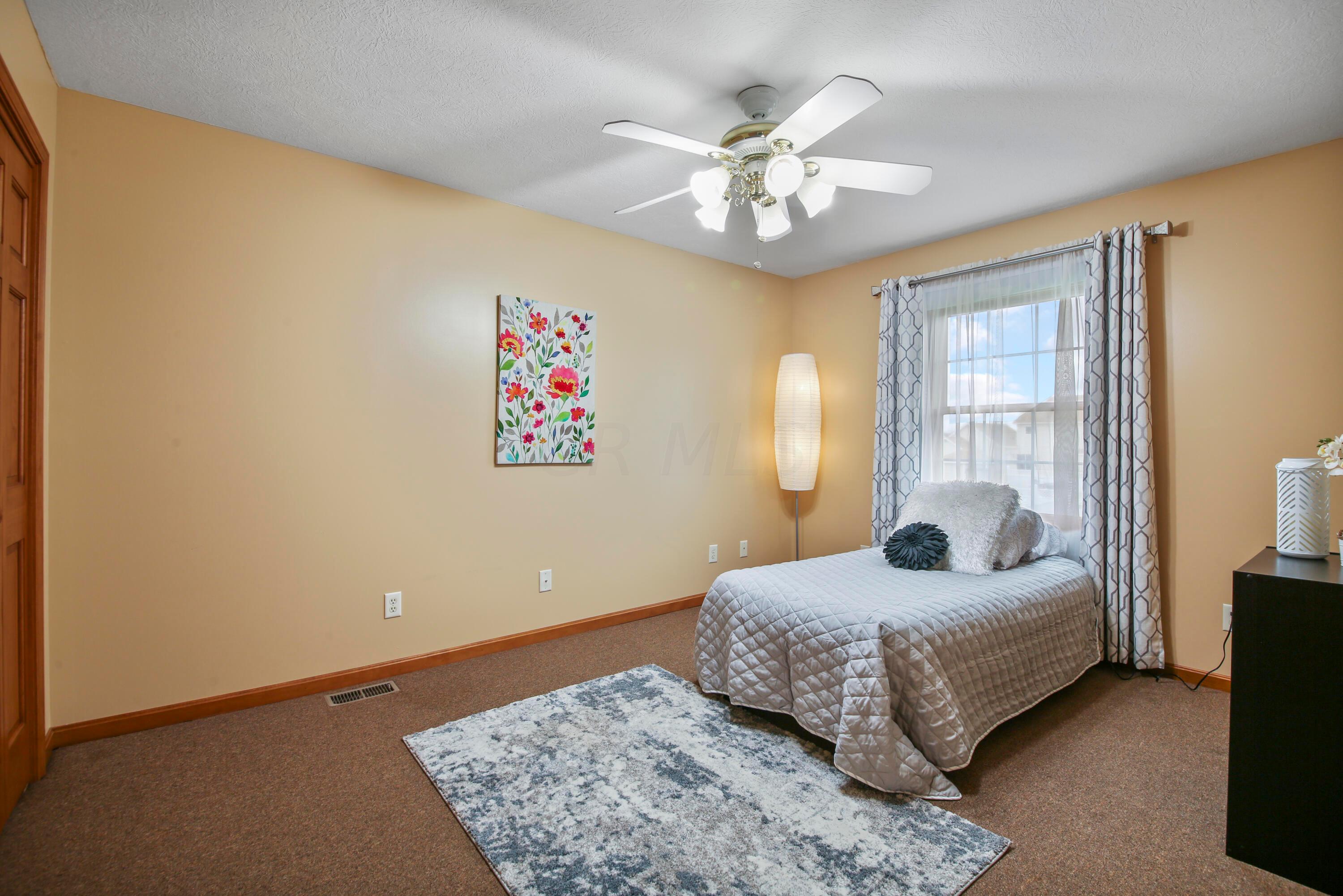 3273 Gooding Road Marion, OH 43302 - Photo 41 of 60 Bedroom # Three 10’8 x 13’7 features single windows w/shade and drapes, double door wall closet, ceiling fan with light fixture and neutral paint.