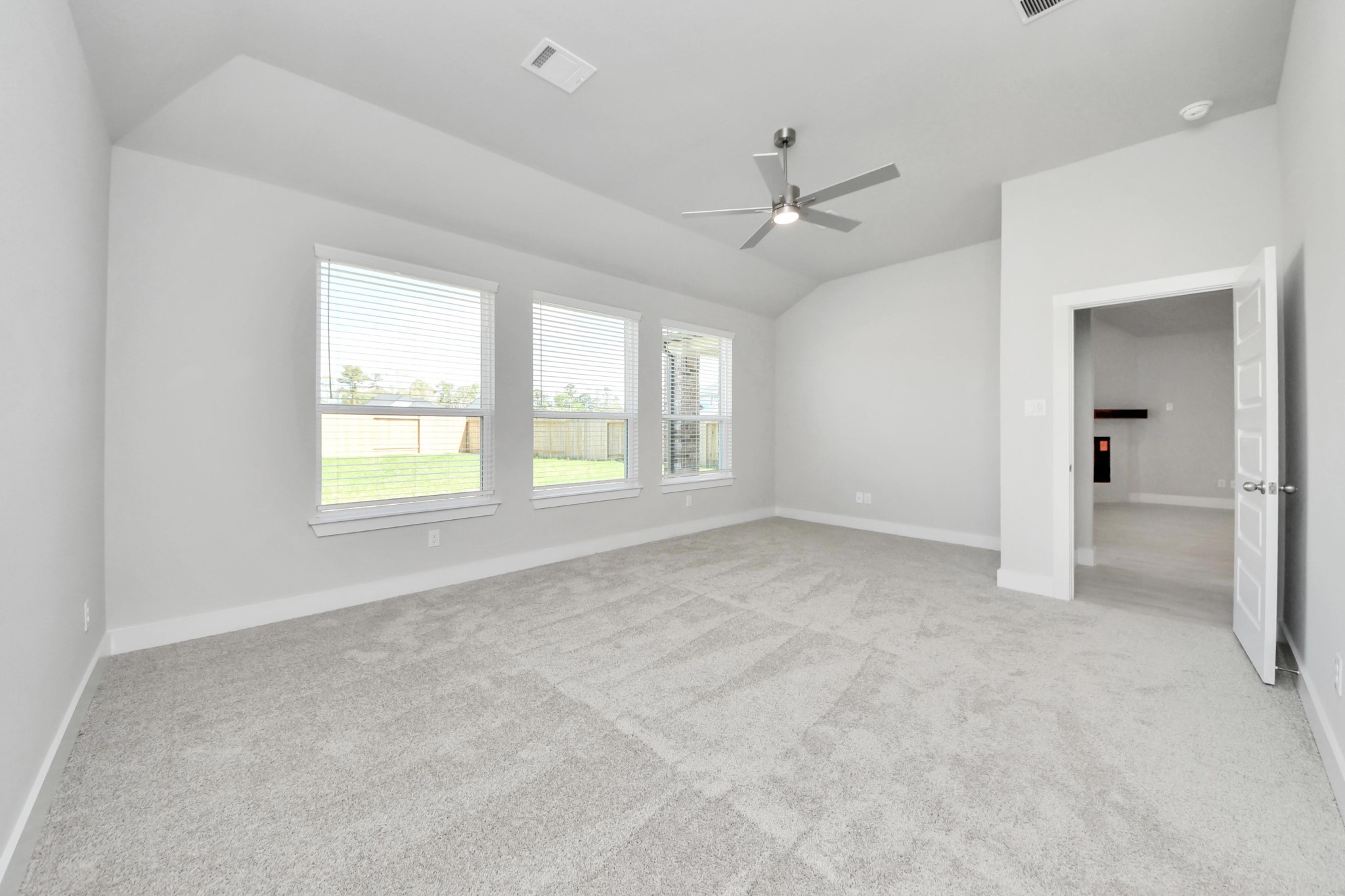 3042 Native Spg Drive Spring, TX 77373 - Photo 24 of 32 Come and unwind after a long day in this magnificent primary suite! This spacious room features plush carpet, warm paint, high ceilings and large windows with privacy blinds. Sample photo of completed home with similar floor plan. Actual colors and selections may vary.
