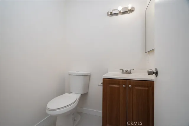 a white toilet sitting next to a bathroom sink