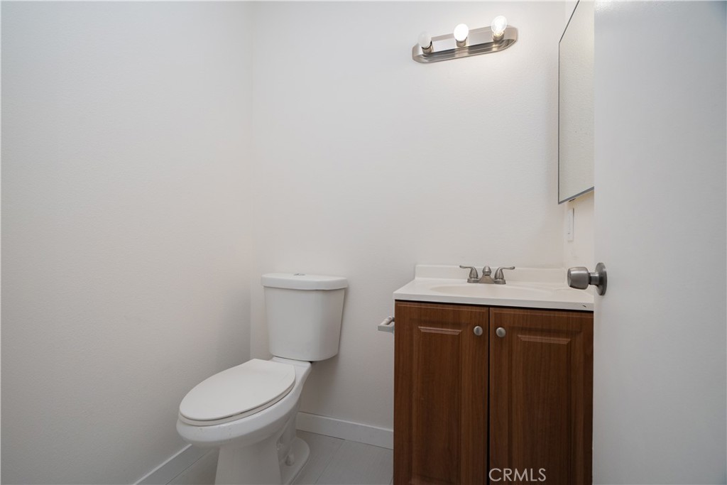 38478 Larkin Avenue, Unit B Palmdale, CA 93550 - Photo 4 of 8 a white toilet sitting next to a bathroom sink