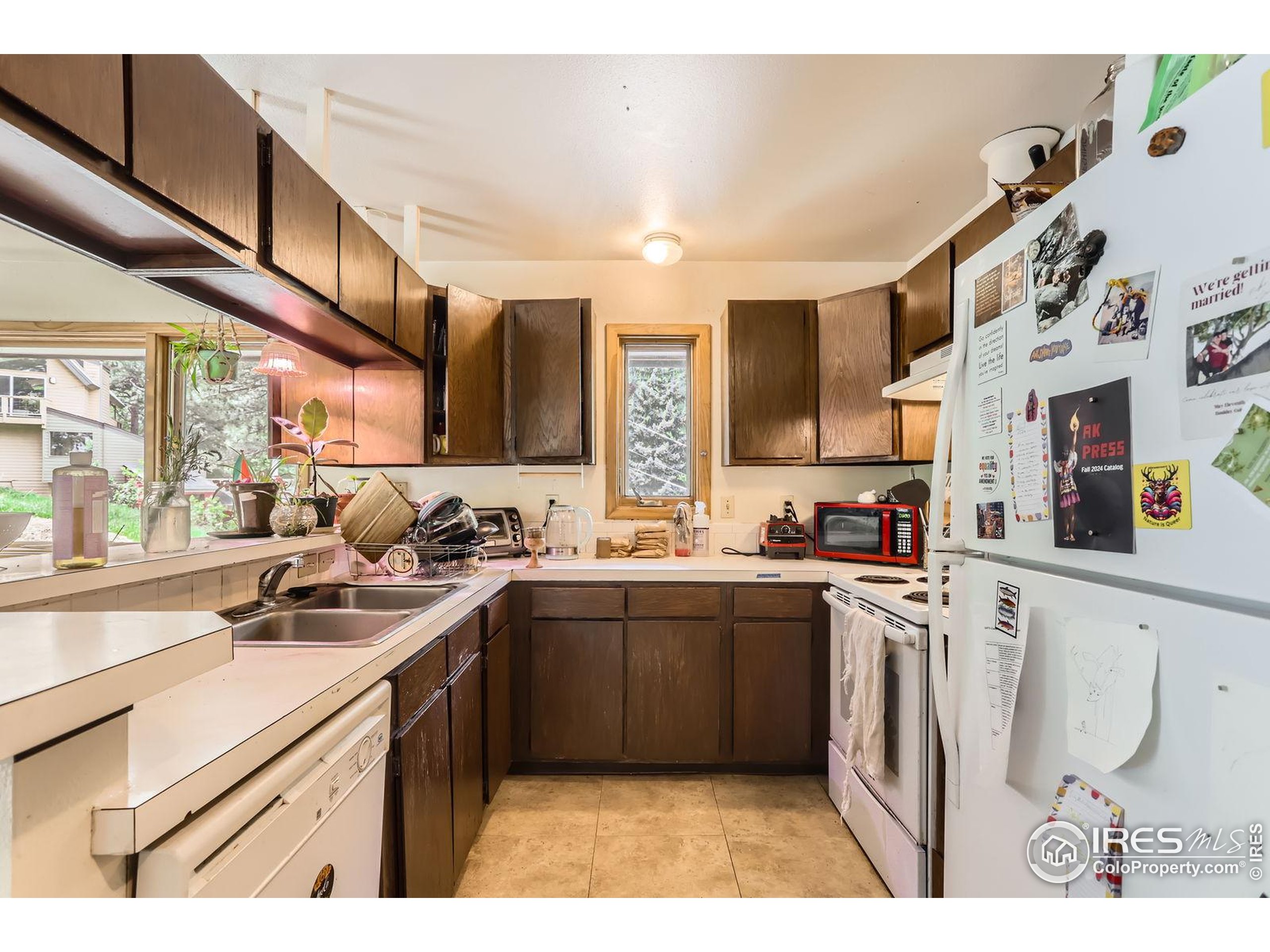27 Arrowleaf Court Boulder, CO 80304 - Photo 14 of 29 a kitchen with stainless steel appliances granite countertop a sink stove and cabinets