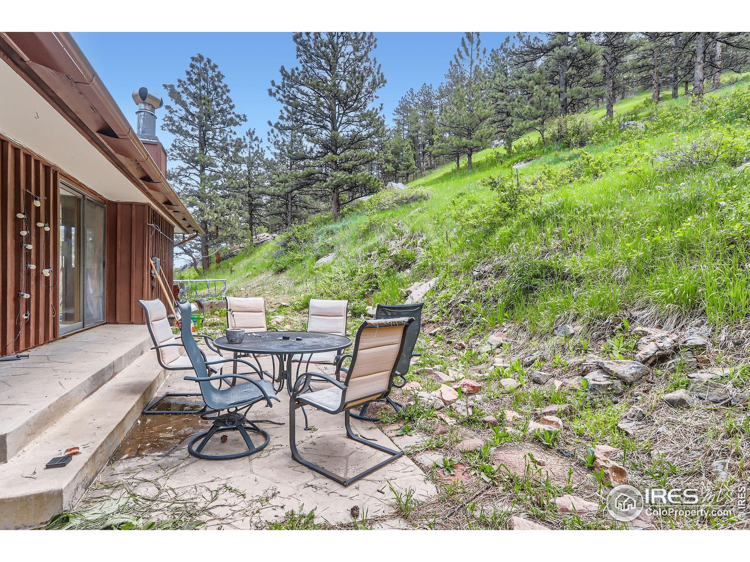 27 Arrowleaf Court Boulder, CO 80304 - Photo 18 of 29 a view of a chairs and table in the back yard of the house