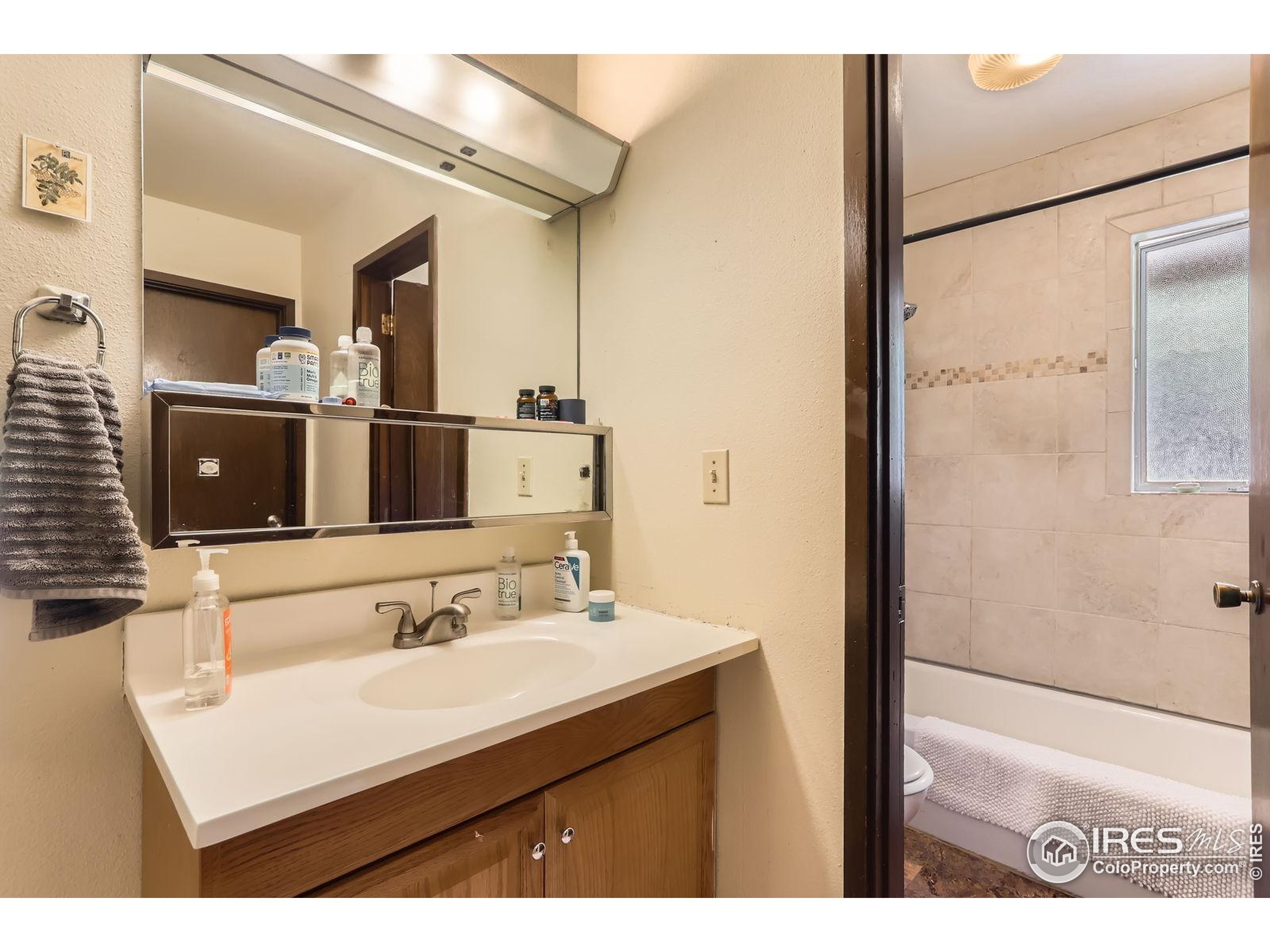 27 Arrowleaf Court Boulder, CO 80304 - Photo 19 of 29 a bathroom with a sink and a mirror