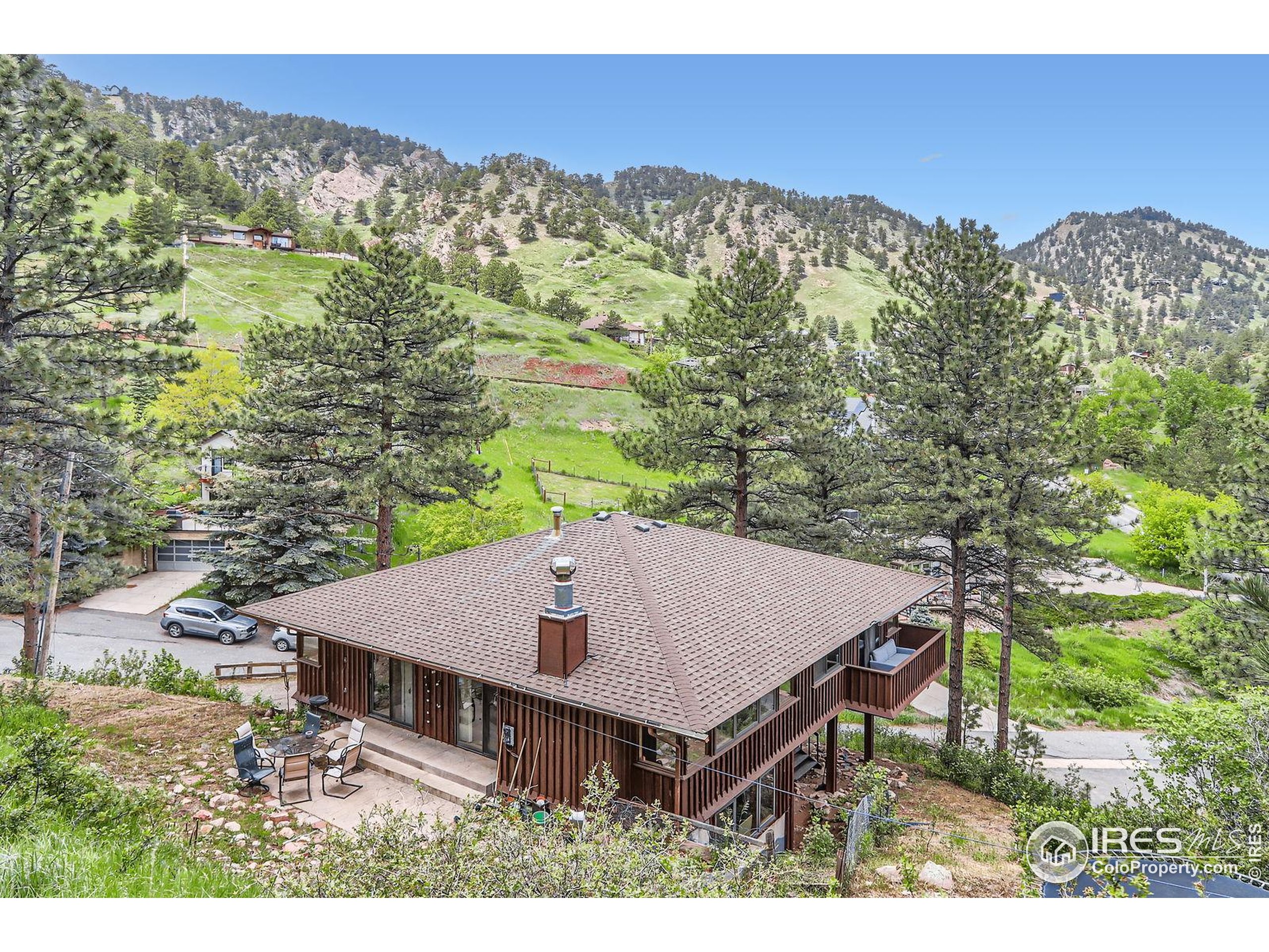27 Arrowleaf Court Boulder, CO 80304 - Photo 27 of 29 a view of a terrace with a table and chairs