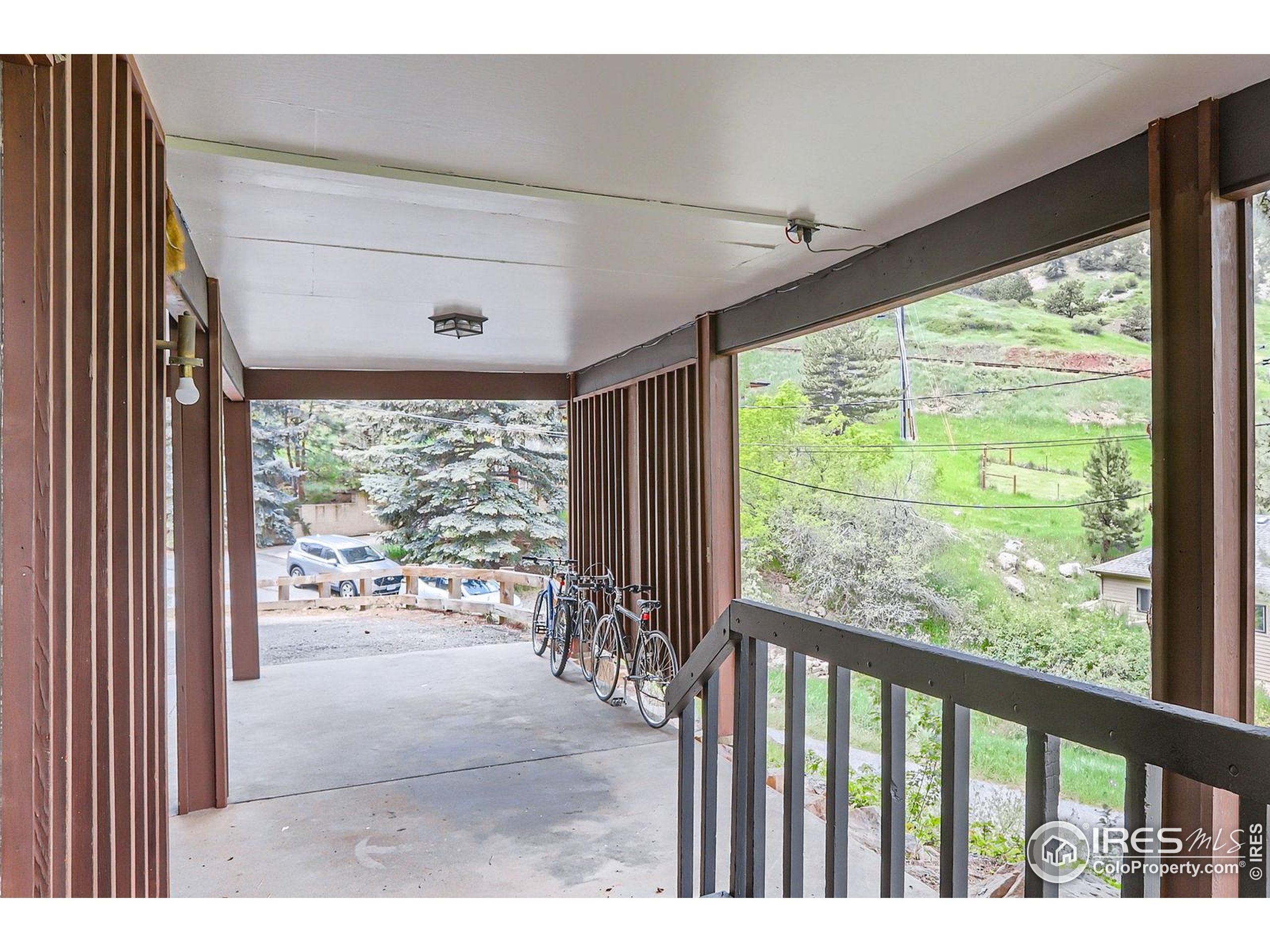 27 Arrowleaf Court Boulder, CO 80304 - Photo 7 of 29 a view of a porch with wooden floor and outdoor space