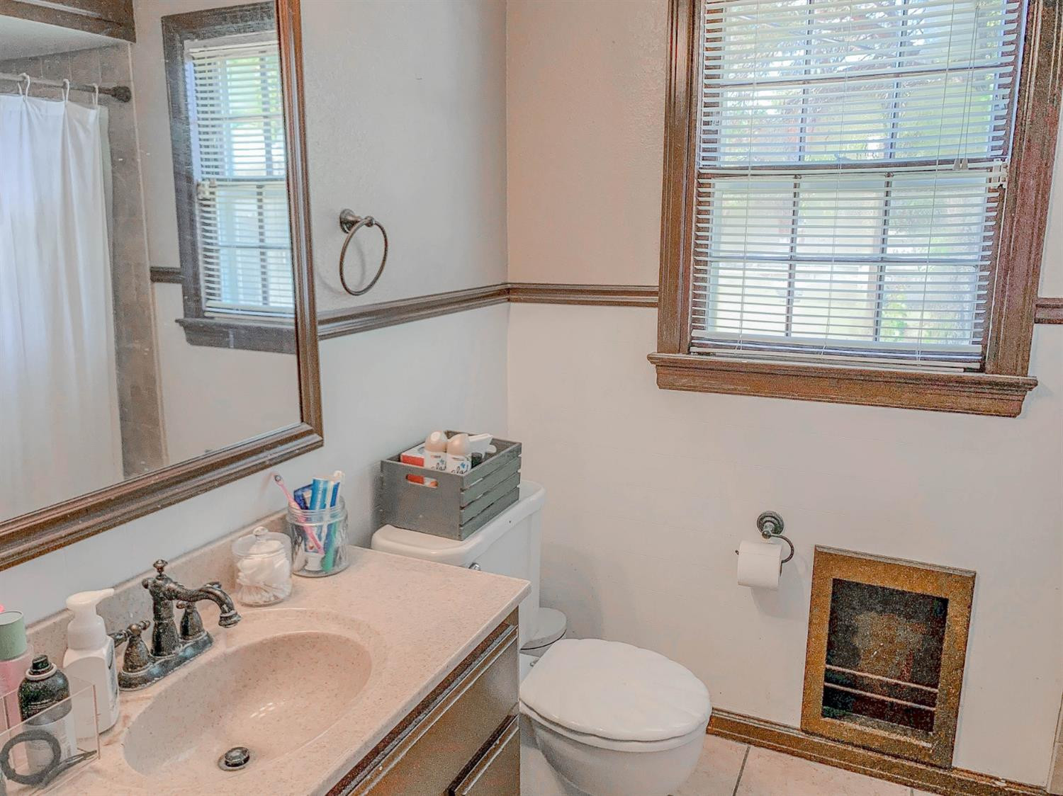 2401 26th Street Lubbock, TX 79411 - Photo 11 of 13 a bathroom with a sink vanity mirror and toilet