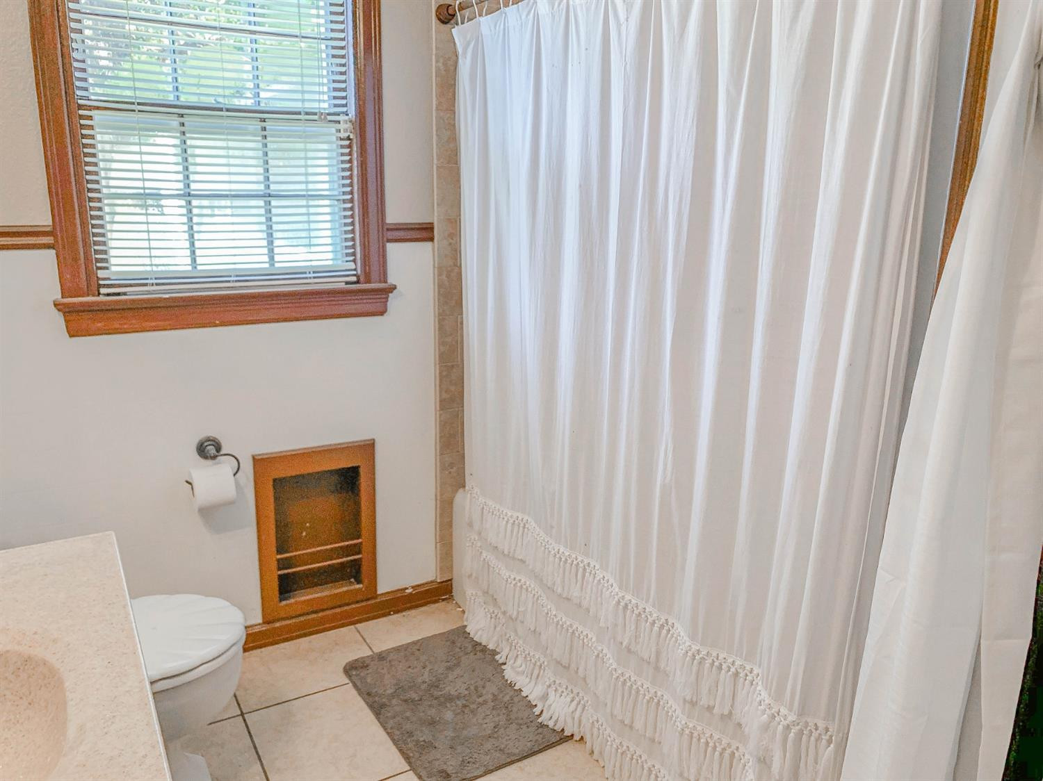 2401 26th Street Lubbock, TX 79411 - Photo 12 of 13 a bathroom with a toilet and a window